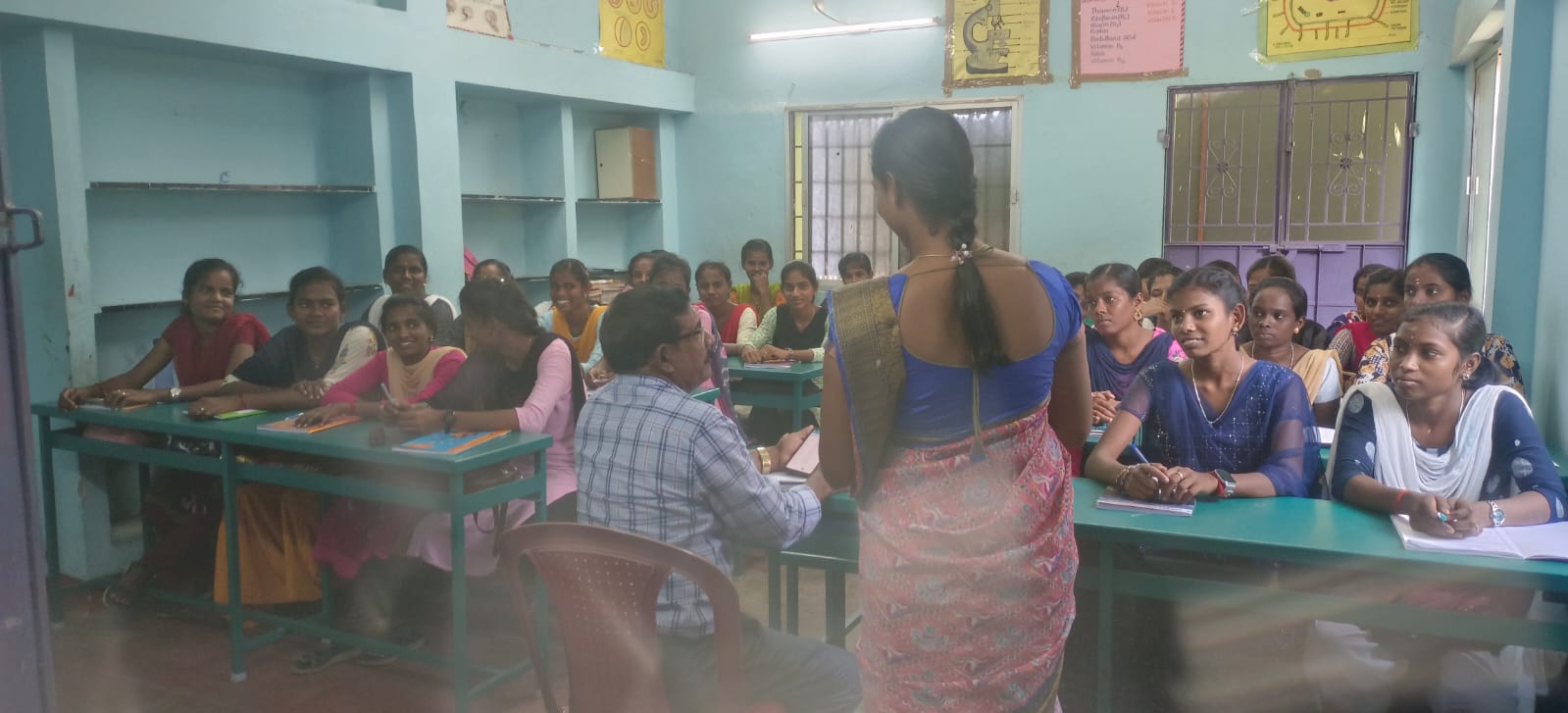 Students interacting with trainers during a classroom activity